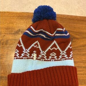 Stylish Knit Beanie with Pom-Pom and winter pattern.